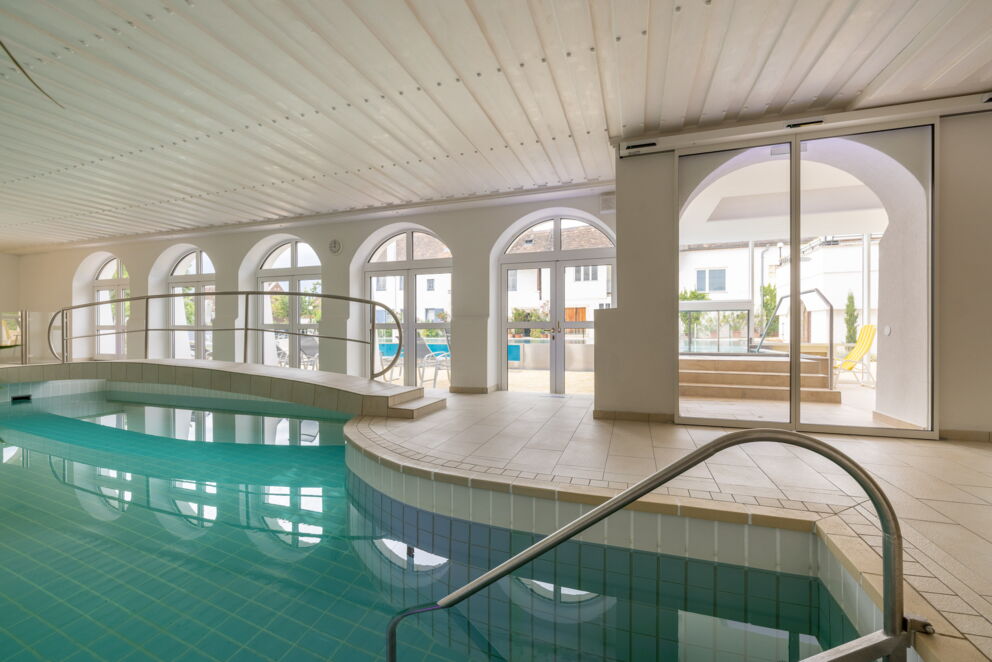 Indoor pool at Hotel Das-Schmidt with beautiful arched windows and a bridge over the indoor pool ©manfred-sodia-photography